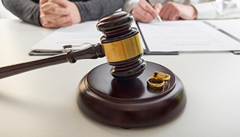 A pair of wedding rings placed on a judge's gavel